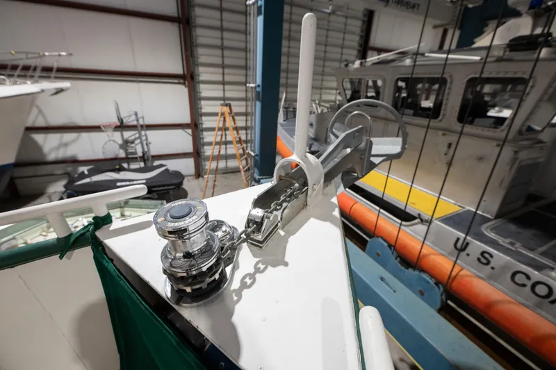 Slide: The Image of 1993 Custom Steel Trawler anchor winch and bow detail in a boatyard. - 8