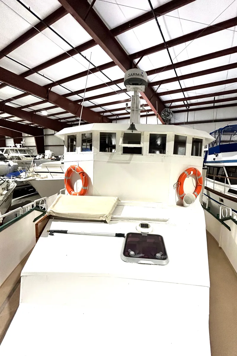 Slide: The Image of 1993 Custom Steel Trawler in indoor storage with life rings and radar. - 9
