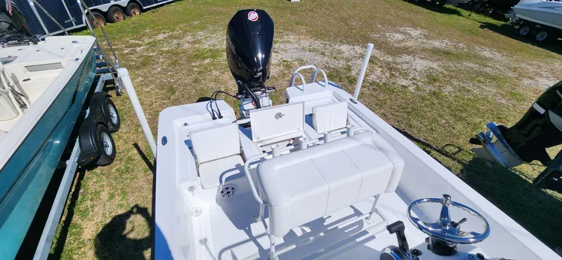 Slide: The Image of 2024 Blazer 2220 Fisherman boat with outboard motor, white interior, and steering wheel. - 7