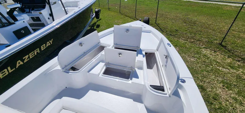 Slide: The Image of 2024 Blazer 2220 Fisherman boat with open storage compartments on deck. - 8