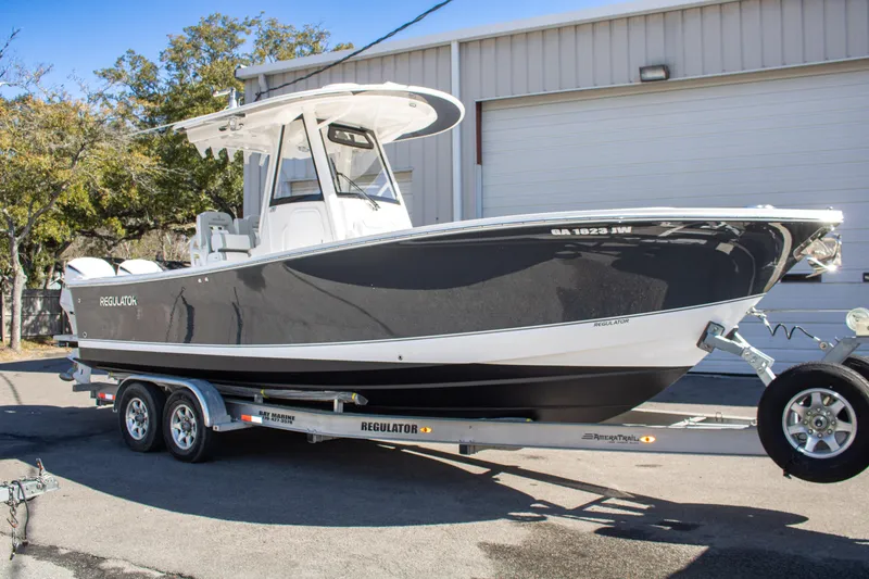 The Image of 2021 Regulator 28 boat on trailer, parked outdoors near a building. - 0