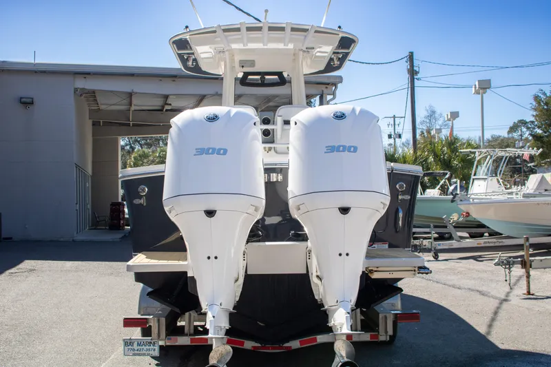 Slide: The Image of 2021 Regulator 28 boat with twin 300 horsepower engines, parked on a trailer. - 10