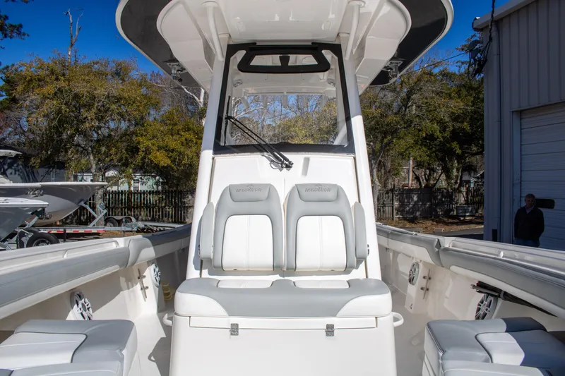 Slide: The Image of 2021 Regulator 28 boat interior with seating and console, outdoors. - 11
