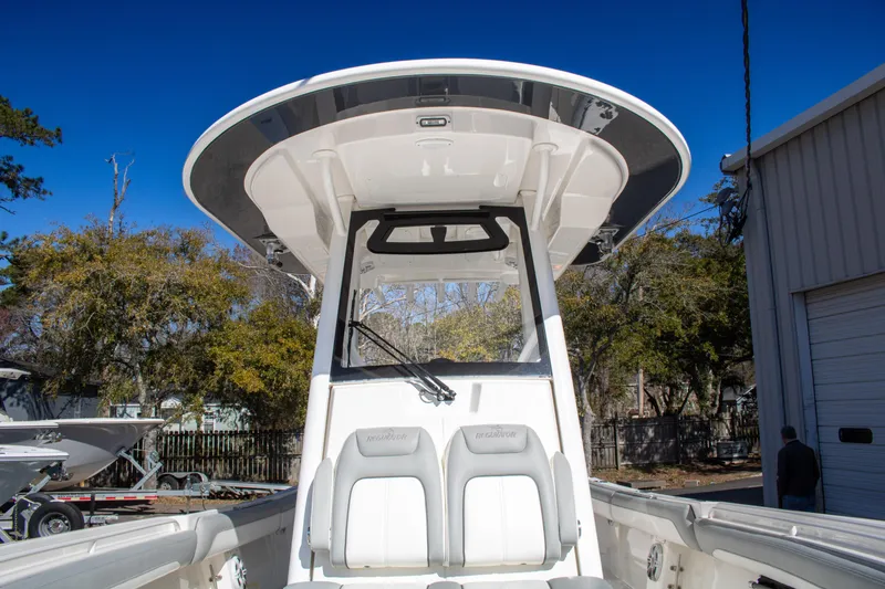 Slide: The Image of 2021 Regulator 28 boat with T-top and dual seats, docked outdoors. - 12