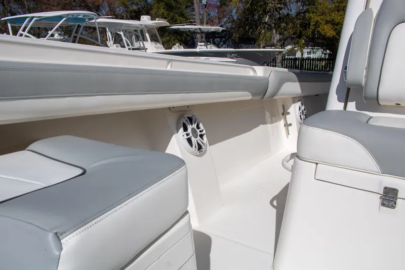Slide: The Image of 2021 Regulator 28 boat interior with white seating and speakers. - 13