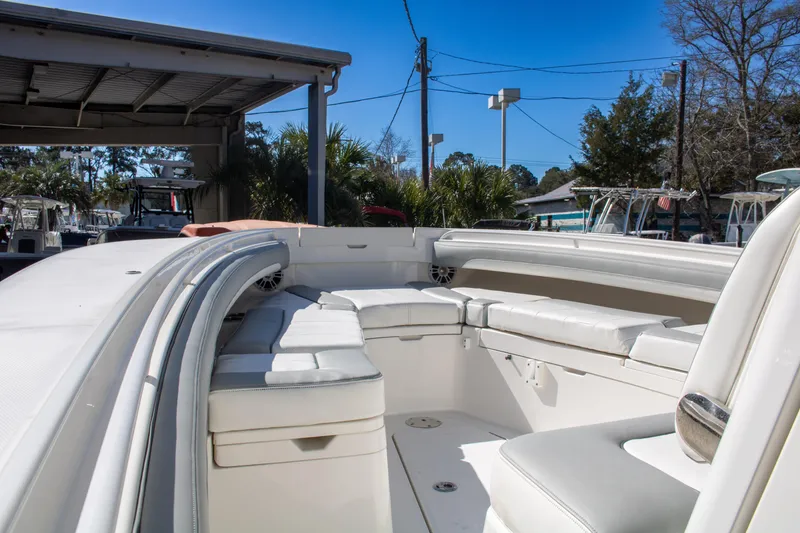 Slide: The Image of 2021 Regulator 28 boat interior with white seating and clear blue sky. - 14