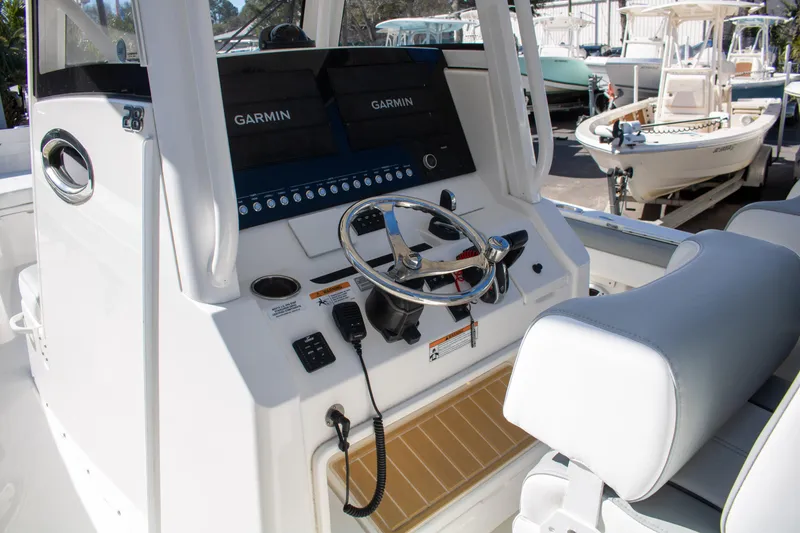 Slide: The Image of 2021 Regulator 28 boat console with Garmin displays and steering wheel. - 18