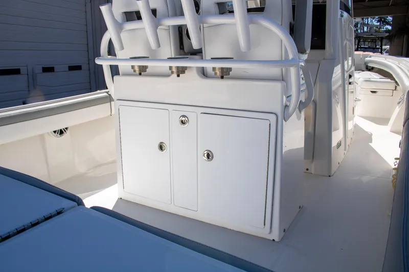 Slide: The Image of 2021 Regulator 28 boat interior with storage compartments and rod holders. - 22