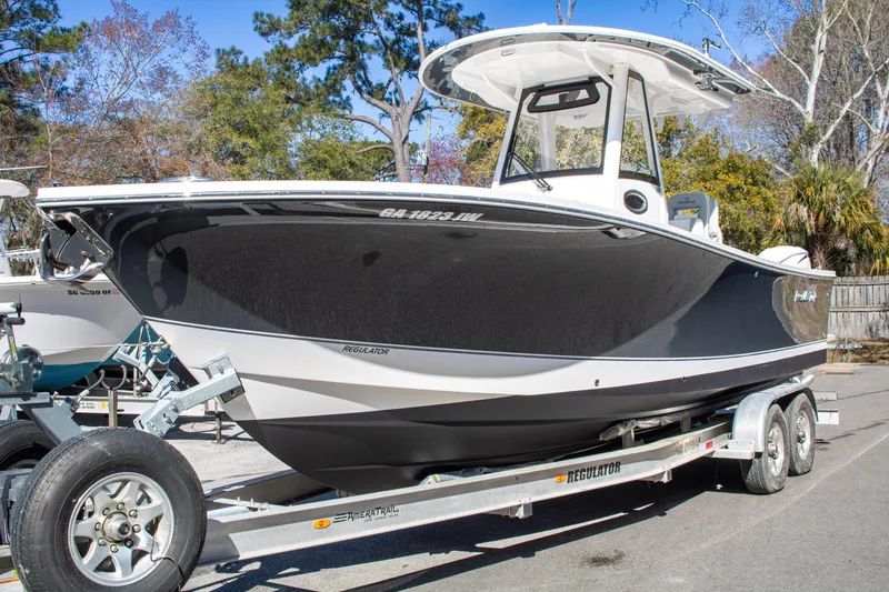 Slide: The Image of 2021 Regulator 28 boat on trailer, parked outdoors. - 3