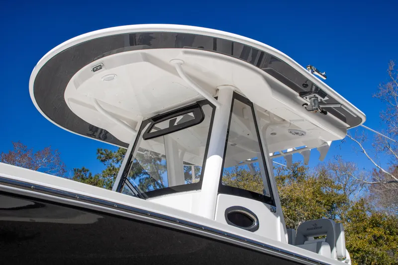 Slide: The Image of 2021 Regulator 28 boat with sleek T-top design against clear blue sky. - 5