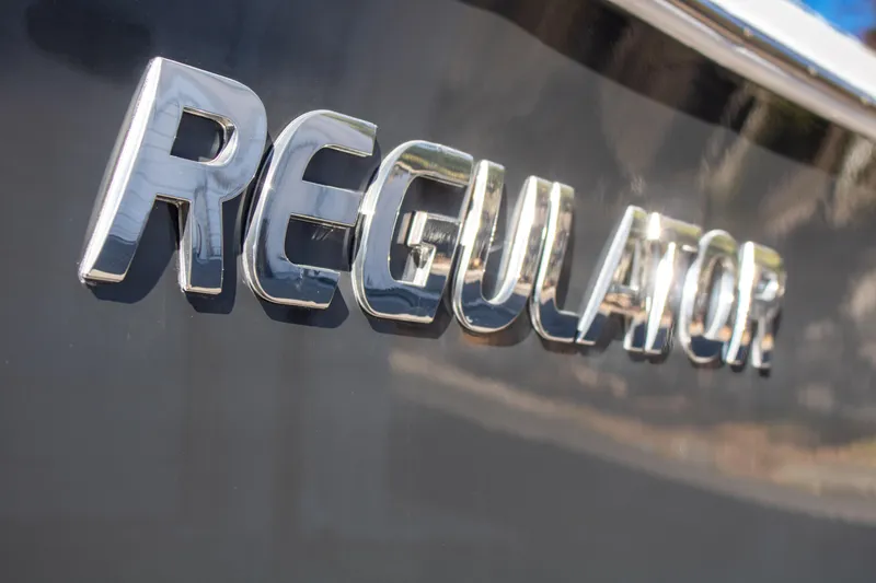 Slide: The Image of Chrome "Regulator" logo on a 2021 Regulator 28 boat. - 7