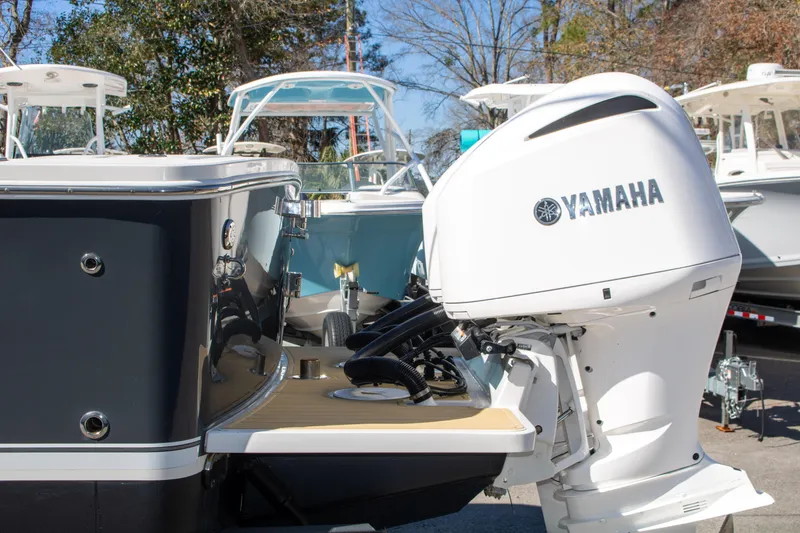 Slide: The Image of 2021 Regulator 28 boat with Yamaha outboard motor, docked outdoors. - 8