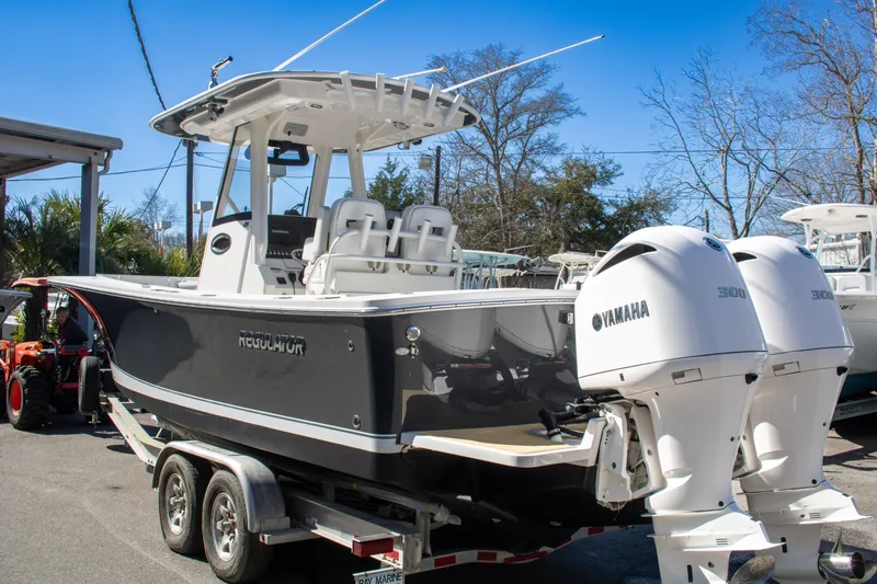 Slide: The Image of 2021 Regulator 28 boat with twin Yamaha engines on a trailer. - 9