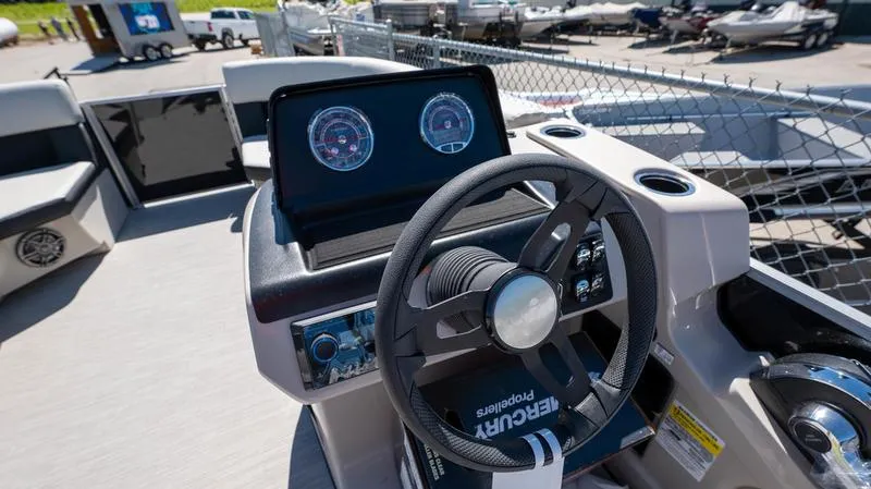 Slide: The Image of 2024 Harris 230 Breeze boat dashboard with steering wheel and gauges. - 15