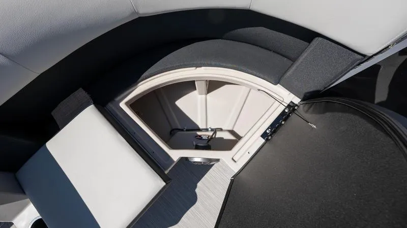 Slide: The Image of 2024 Harris 230 Breeze boat interior storage compartment with cushioned seating. - 18