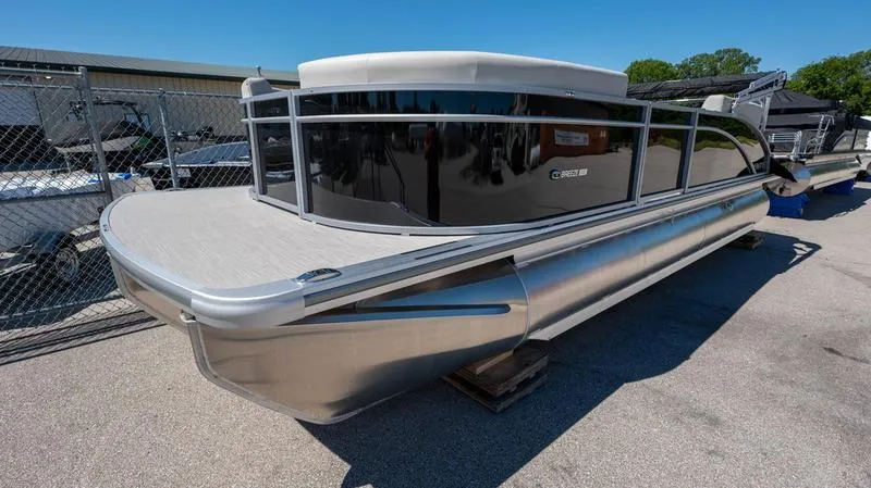Slide: The Image of 2024 Harris 230 Breeze pontoon boat on display outdoors. - 24