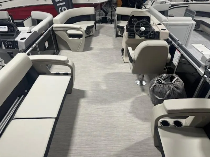 Slide: The Image of 2024 Harris 230 Breeze pontoon boat interior with beige seating and modern helm. - 7