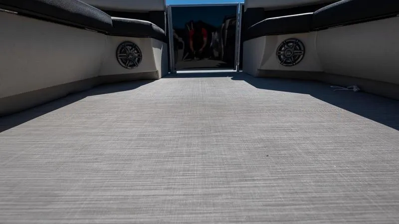 Slide: The Image of Interior of 2024 Harris 230 Breeze pontoon boat with spacious deck and built-in speakers. - 8