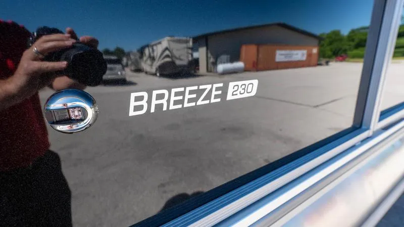 Slide: The Image of 2024 Harris 230 Breeze boat model nameplate with reflection. - 9