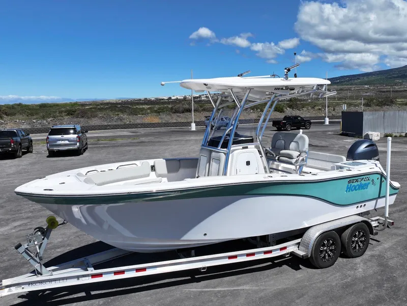 The Image of 2021 Sea Fox 228 Commander boat on trailer, parked outdoors under blue sky. - 1