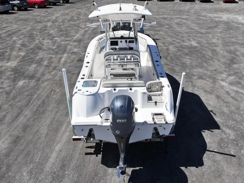 Slide: The Image of 2021 Sea Fox 228 Commander boat with outboard motor, viewed from the rear on a gravel surface. - 4