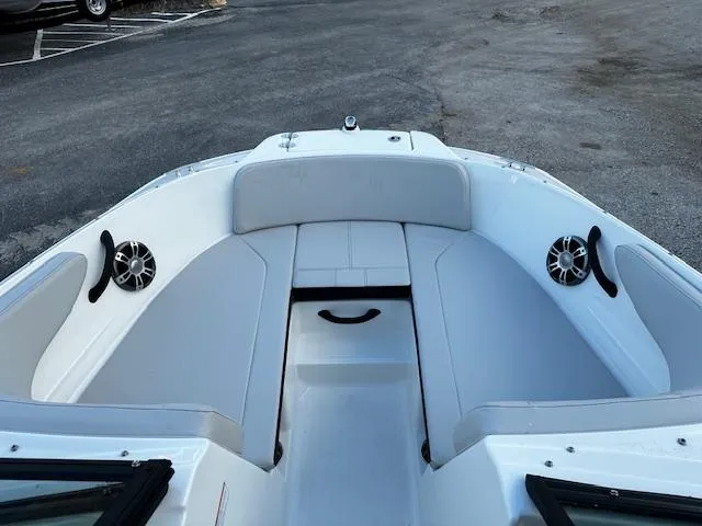 Slide: The Image of 2024 Sea Ray SPX 210 Outboard boat interior with spacious seating and speakers. - 13