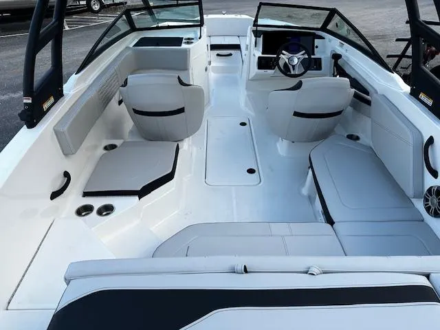 Slide: The Image of 2024 Sea Ray SPX 210 Outboard boat interior with modern seating and steering console. - 2