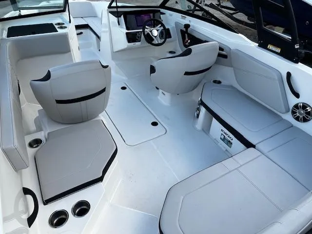 Slide: The Image of 2024 Sea Ray SPX 210 Outboard boat interior with sleek seating and modern dashboard. - 3