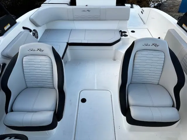Slide: The Image of 2024 Sea Ray SPX 210 Outboard boat interior with white seating and black accents. - 5