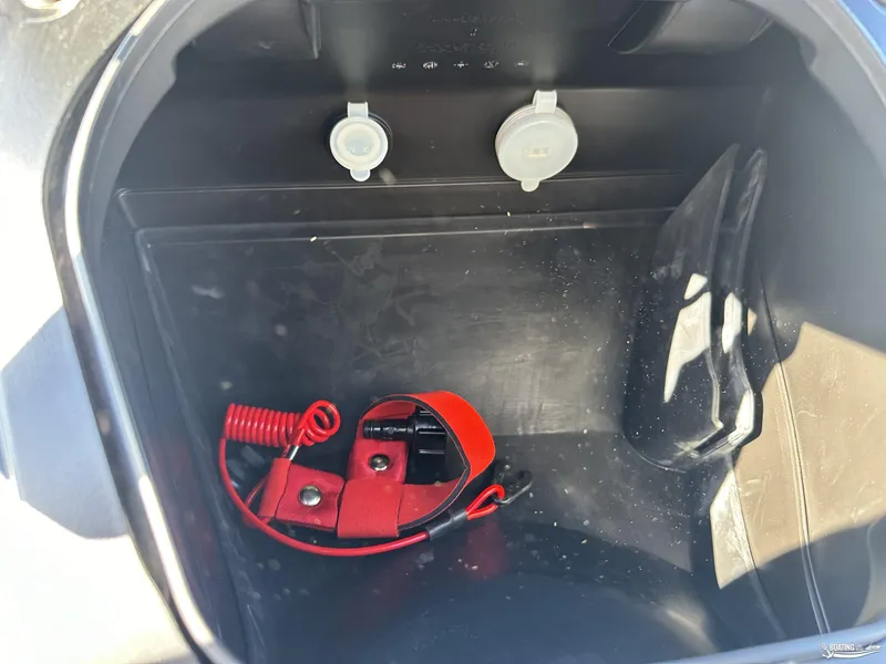 Slide: The Image of 2024 Yamaha WaveRunner VX Cruiser storage compartment with red safety lanyard. - 5