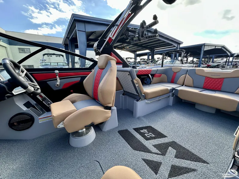 Slide: The Image of 2024 MasterCraft XT24 boat interior with luxurious seating and modern design. - 10