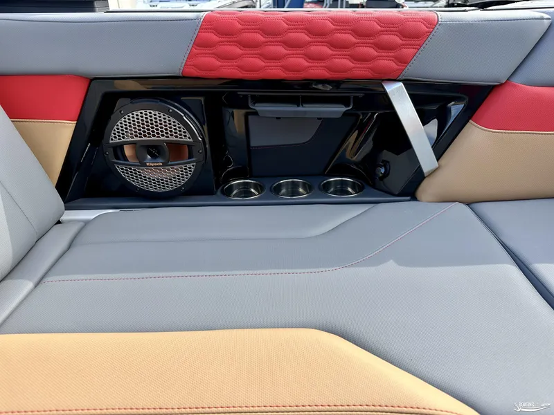 Slide: The Image of 2024 MasterCraft XT24 interior with Klipsch speaker, cup holders, and stylish upholstery. - 12