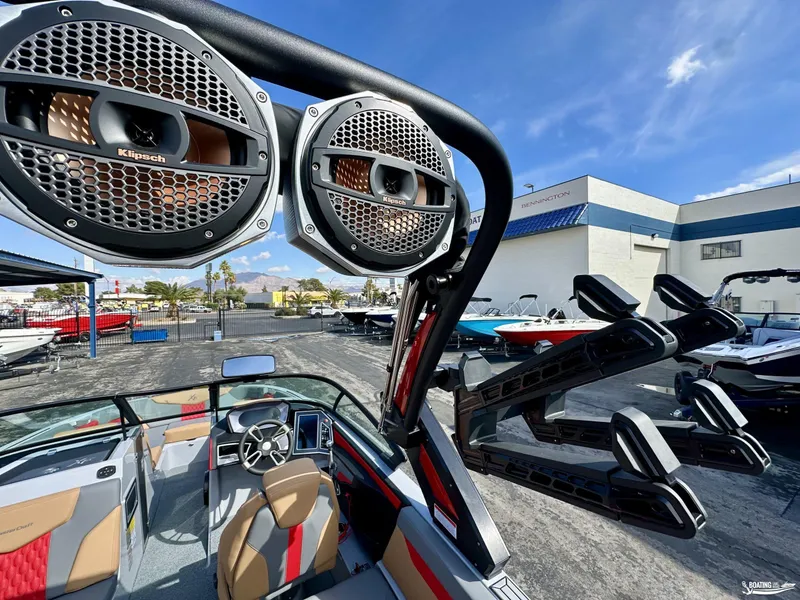 Slide: The Image of 2024 MasterCraft XT24 boat with Klipsch speakers and sleek interior design. - 13