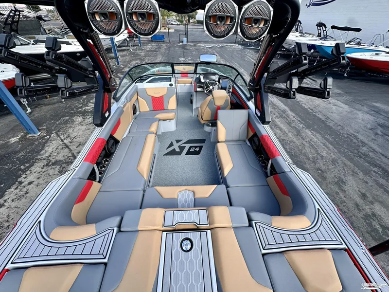 Slide: The Image of 2024 MasterCraft XT24 boat interior with spacious seating and advanced audio system. - 8