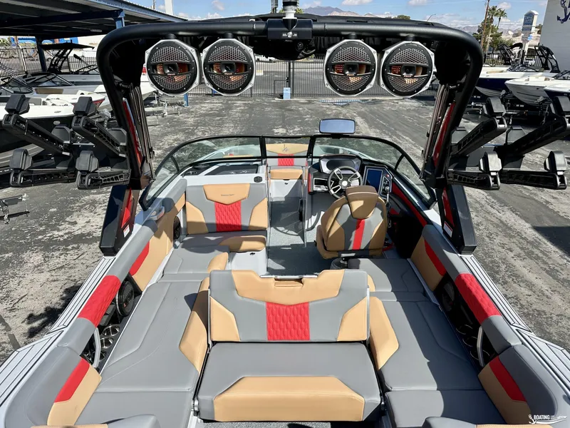Slide: The Image of 2024 MasterCraft XT24 boat interior with stylish seating and advanced audio system. - 9