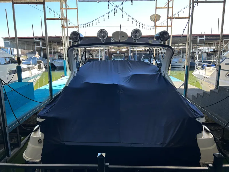 Slide: The Image of 2004 Regal Commodore 3560 IO boat covered at marina dock. - 10