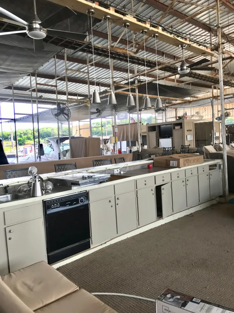 Slide: The Image of Industrial kitchen setup with appliances and cabinets in a spacious, open warehouse environment. - 2