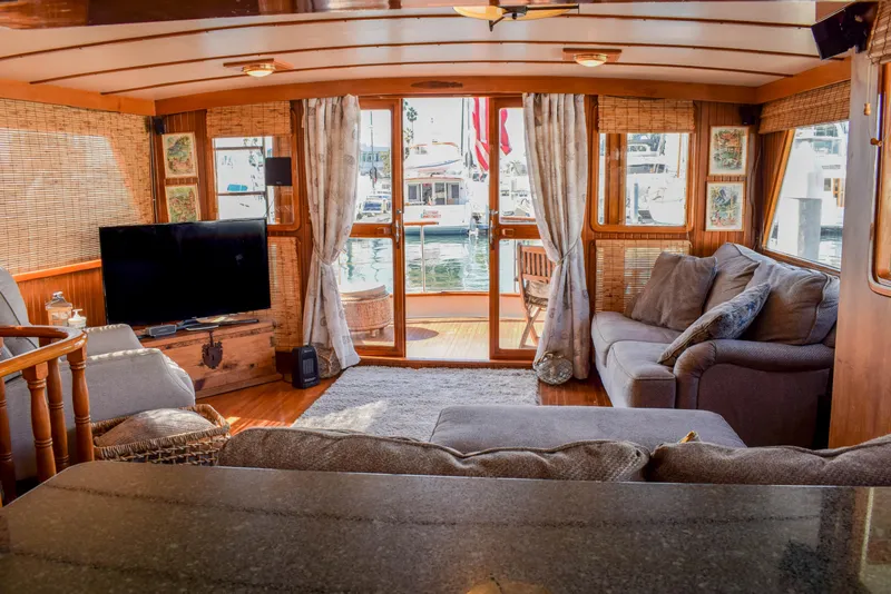 Slide: The Image of Cozy interior of 1984 Angel Defever LRC yacht with plush seating and waterfront view. - 10