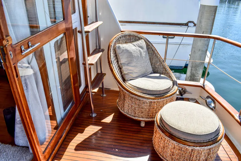 Slide: The Image of Cozy seating on 1984 Angel Defever LRC yacht deck with wicker chair and ottoman. - 14