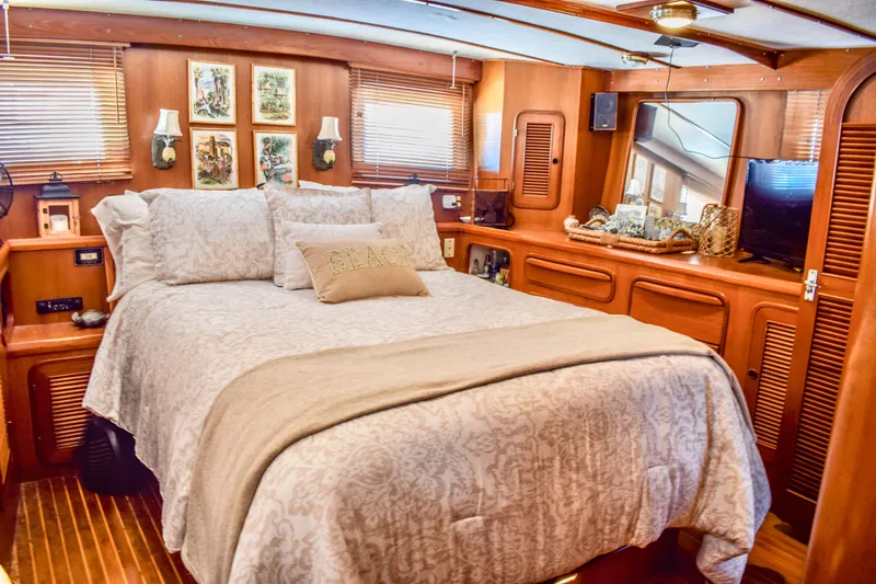 Slide: The Image of Luxurious 1984 Angel Defever LRC yacht bedroom with elegant wood paneling and cozy bedding. - 16