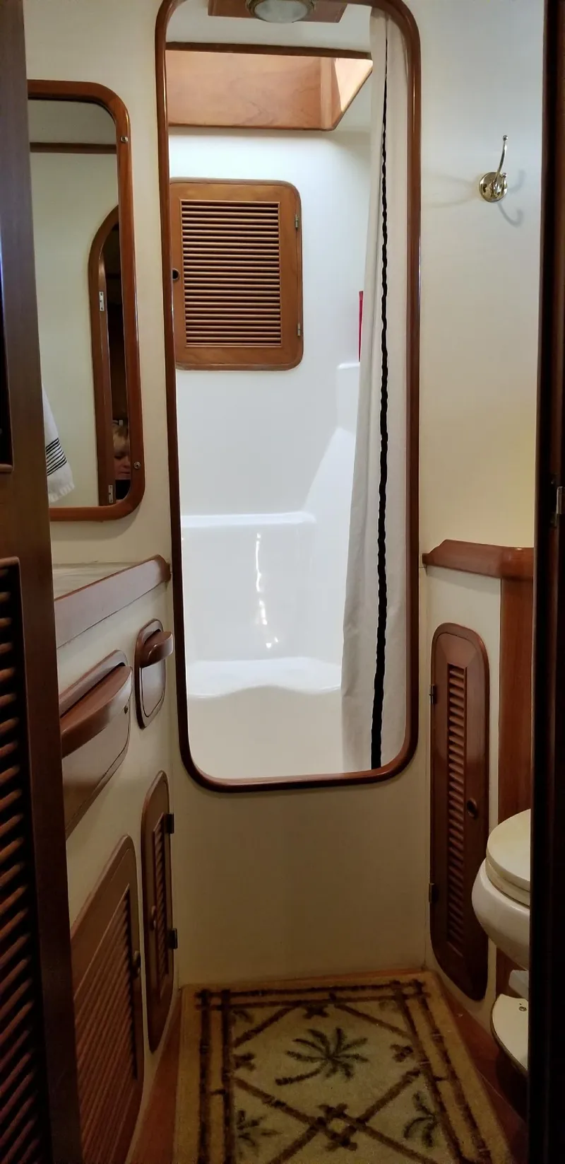 Slide: The Image of 1984 Angel Defever LRC yacht bathroom with wooden accents and nautical decor. - 19