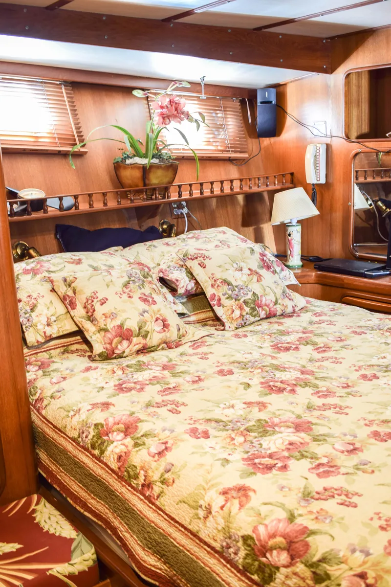 Slide: The Image of Cozy 1984 Angel Defever LRC cabin with floral bedding and wooden interior. - 20