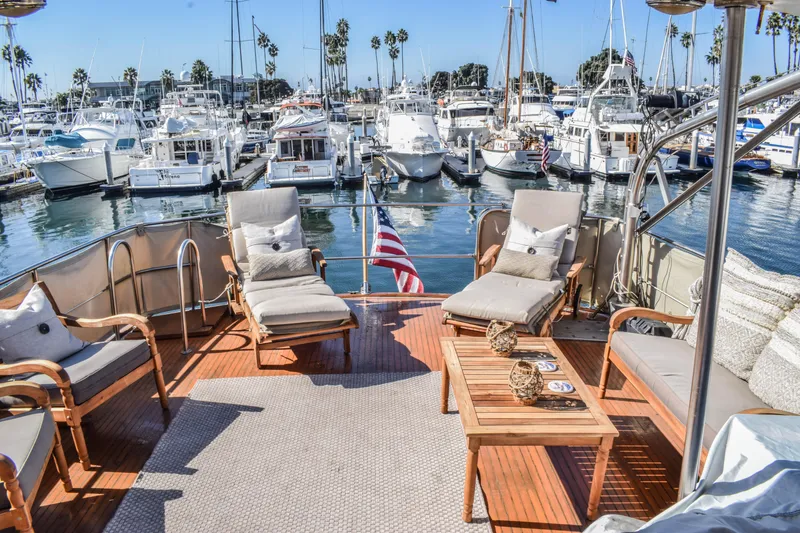 Slide: The Image of Luxurious 1984 Angel Defever LRC yacht deck with comfortable seating in a marina setting. - 3