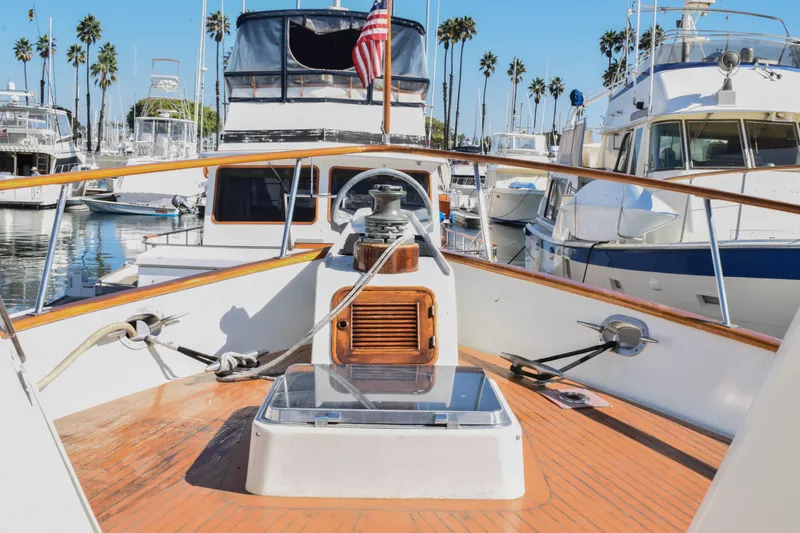 Slide: The Image of 1984 Angel Defever LRC yacht deck with American flag, docked in marina. - 5