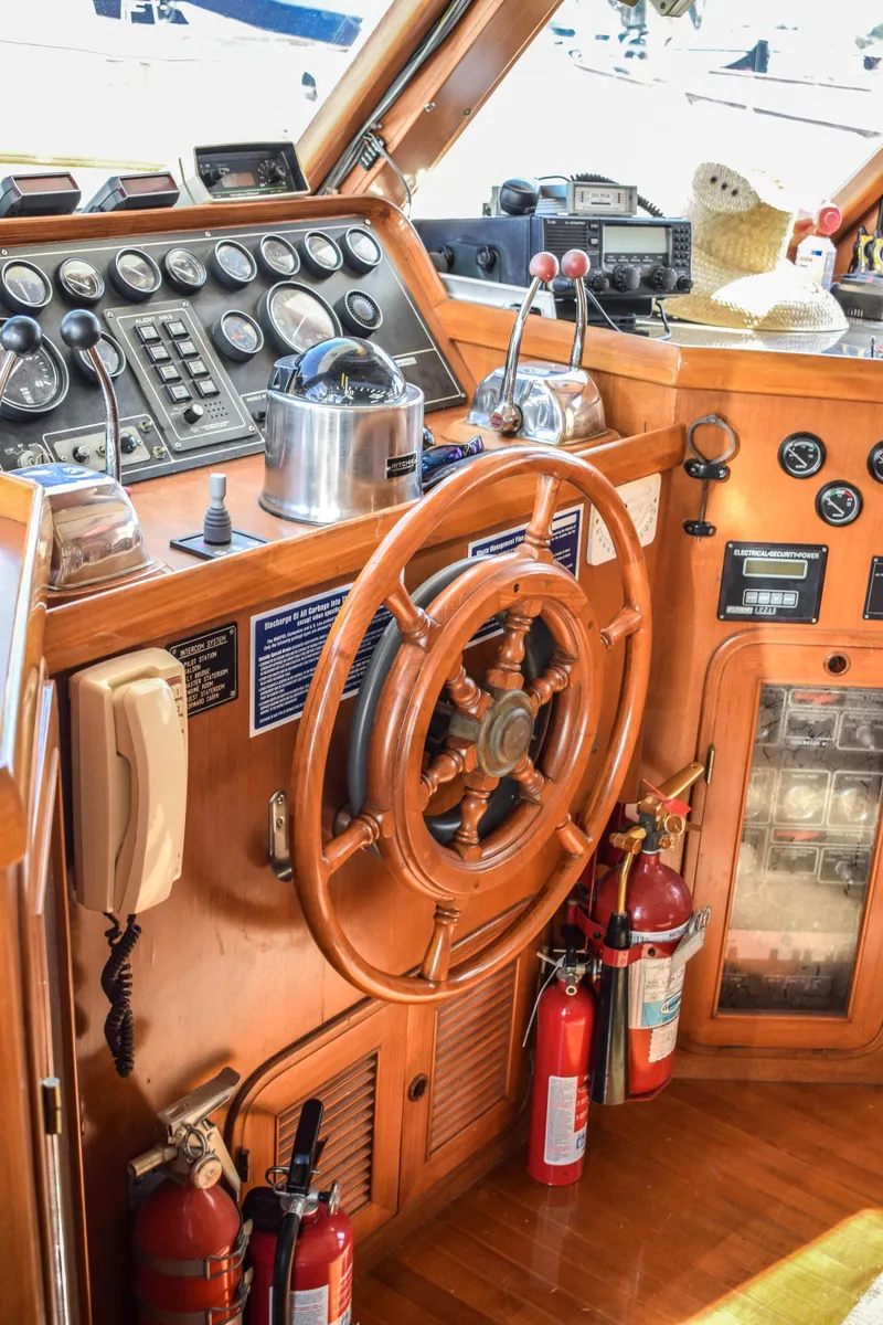 Slide: The Image of 1984 Angel Defever LRC yacht helm with wooden wheel and navigation instruments. - 6