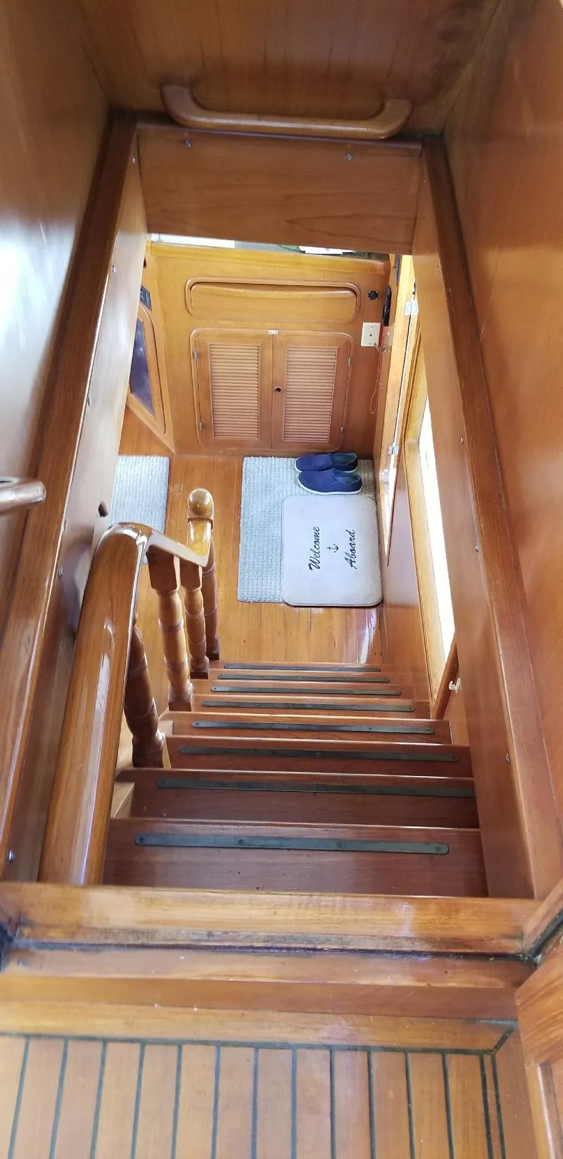 Slide: The Image of Wooden staircase inside 1984 Angel Defever LRC yacht, featuring polished handrails and nautical decor. - 8