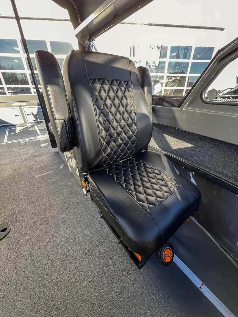 Slide: The Image of 2024 North River 25 Seahawk interior with luxurious black leather seat and diamond stitching. - 12
