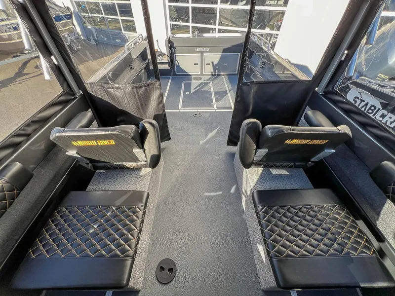 Slide: The Image of Interior of 2024 North River 25 Seahawk boat with black quilted seating. - 14