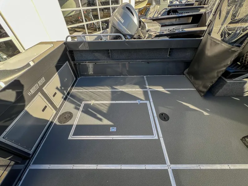 Slide: The Image of 2024 North River 25 Seahawk boat deck with storage compartments and Yamaha engine. - 18