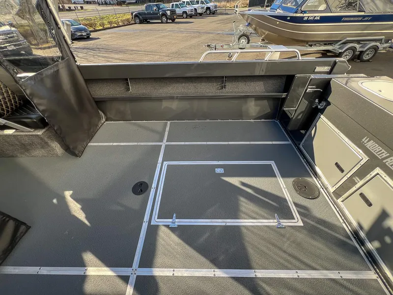 Slide: The Image of 2024 North River 25 Seahawk boat interior with spacious deck and storage compartments. - 19